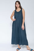 Woman wearing a blue sleeveless jumpsuit on a white background