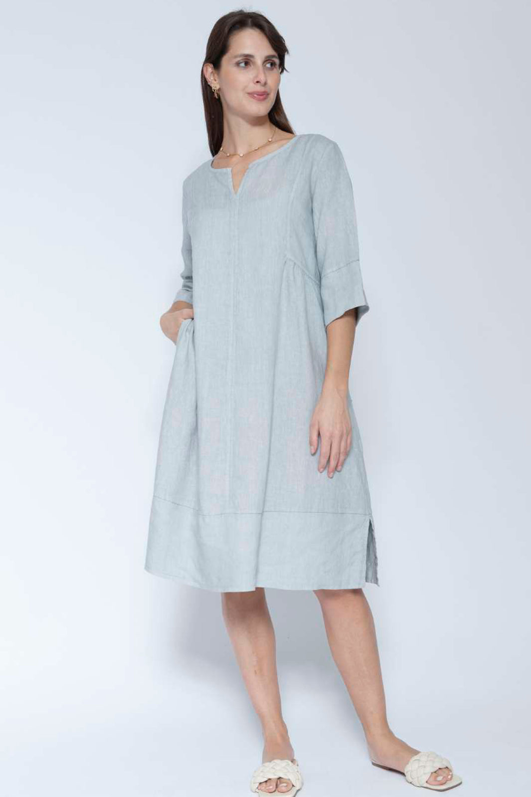 Woman wearing a light blue dress on a white background