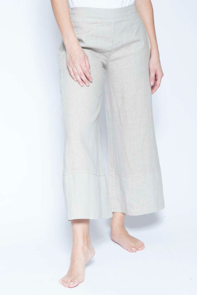 Light-colored wide-leg pants worn by a person on a white background