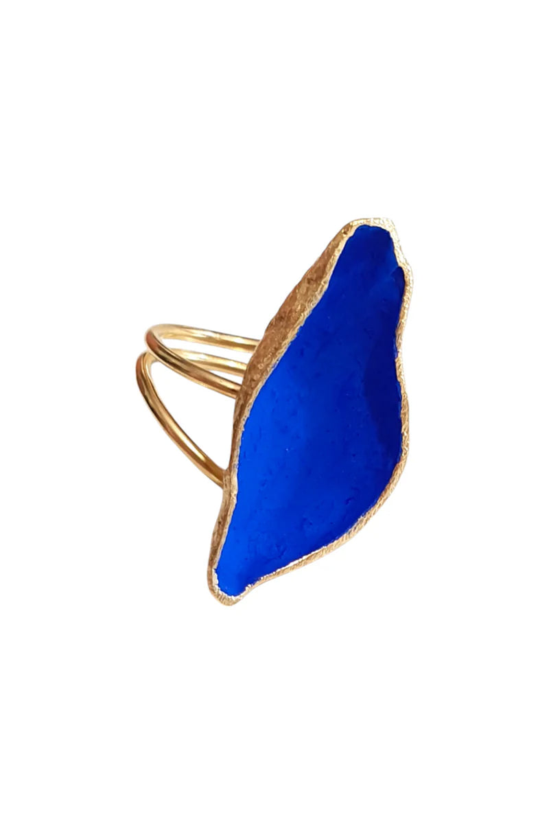 Gold ring with a blue stone on a white background