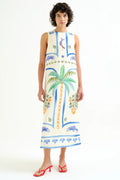 Woman wearing a sleeveless dress with tropical patterns on a white background
