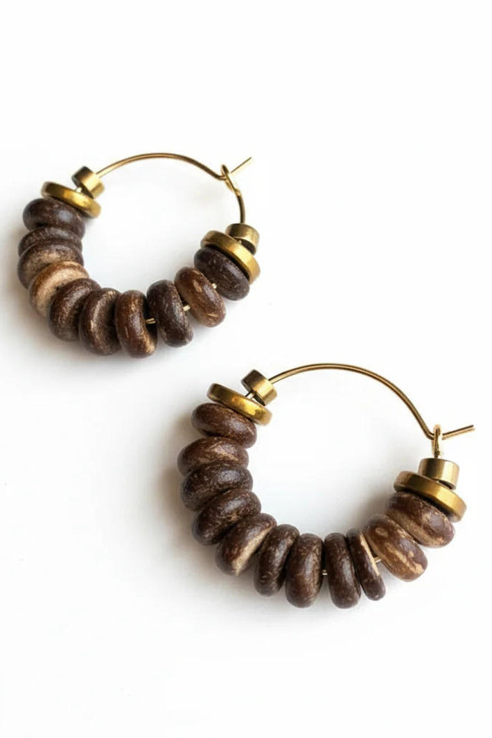 Pair of hoop earrings with brown beads and gold accents on a white background