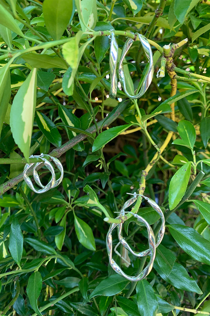 LBJ Jewellery Medium Oval Twist Silver Hoops E1662/3, styled on leaves