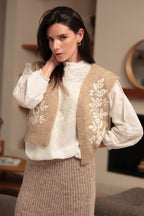 Luna Llena Leire Beige Sleeveless Jacket VE150, three-quarter view styled with a knit skirt