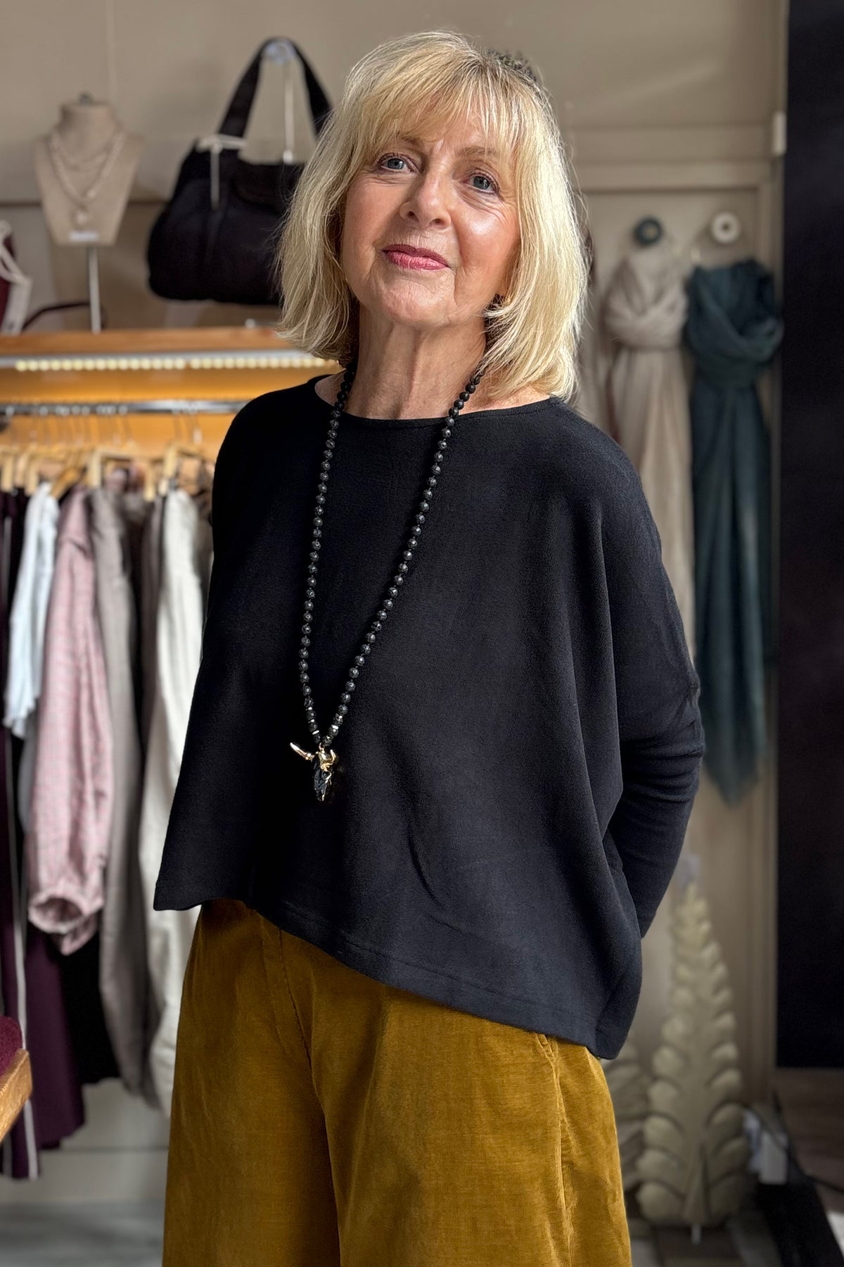 Mama B Rita Nero Black Jumper One Size, front view styled with mustard cord trousers