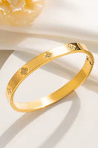 Misgraceful Clover Gold Bracelet Bangle, styled flat lay
