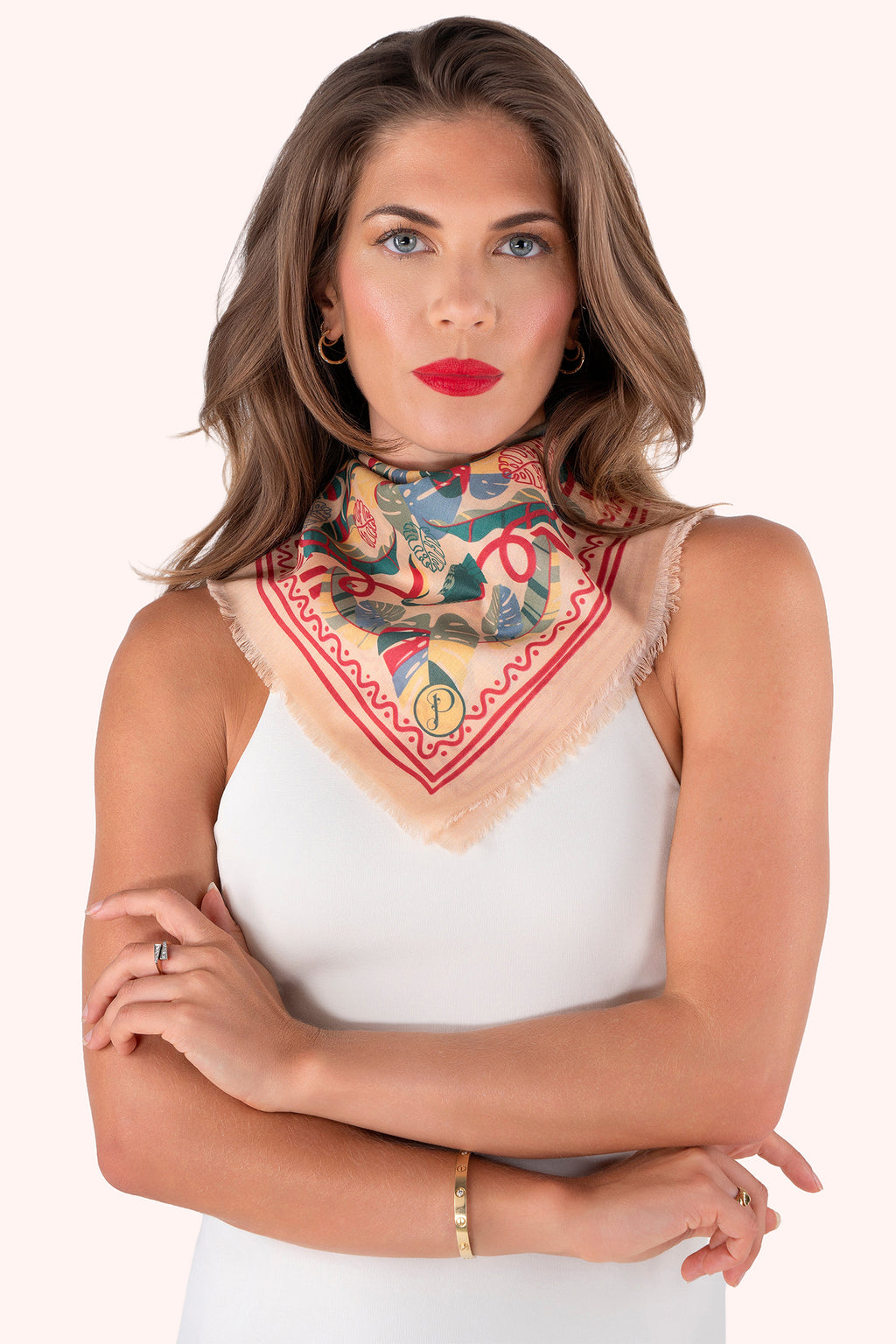 Woman wearing a colorful patterned scarf on her neck against a white background