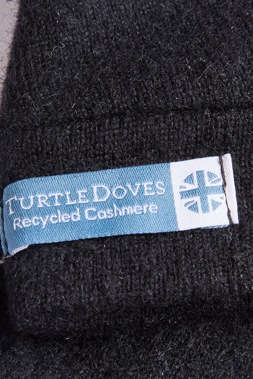 Turtle Doves Black Cashmere Fingerless Gloves, cuff label close-up