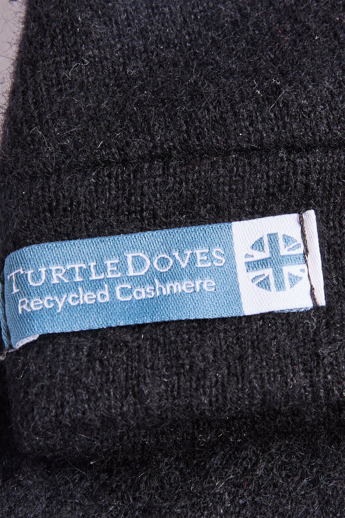 Turtle Doves Black Cashmere Fingerless Gloves, cuff label close-up