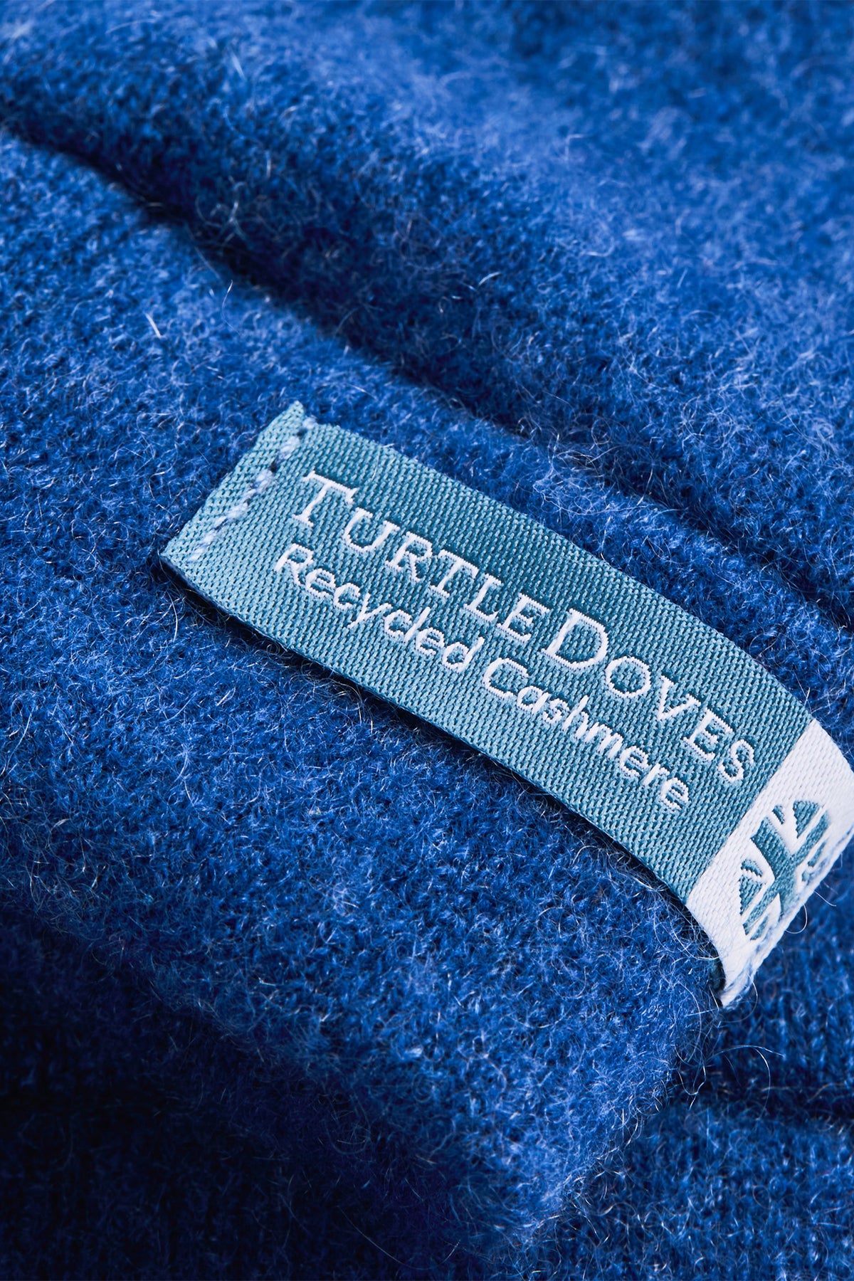 Turtle Doves Denim Blue Cashmere Fingerless Gloves, cuff label close-up