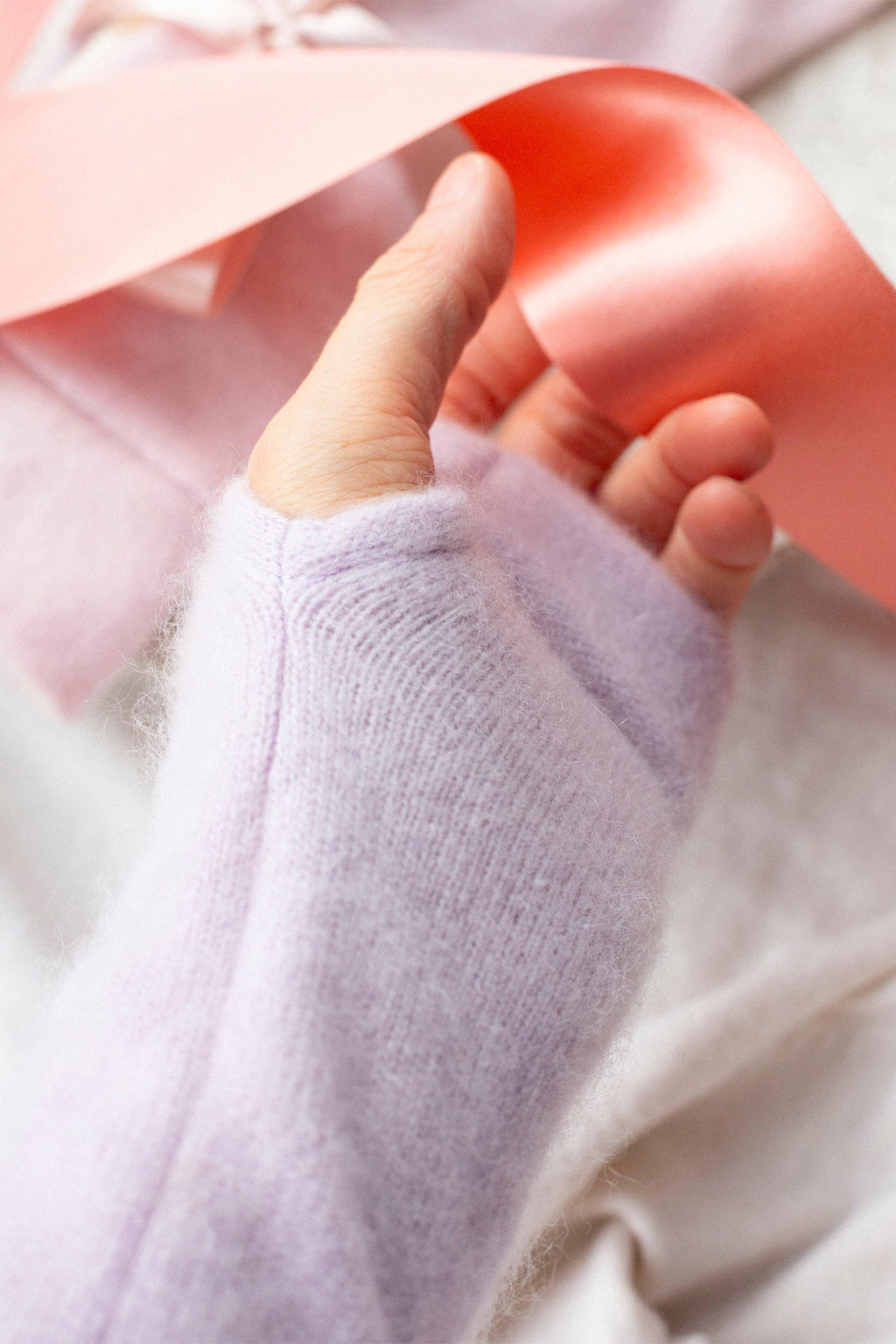 Turtle Doves Lilac Purple Cashmere Fingerless Gloves, worn on hand with ribbon