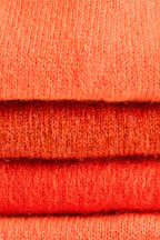 Turtle Doves Orange Cashmere Fingerless Gloves, knit texture close-up