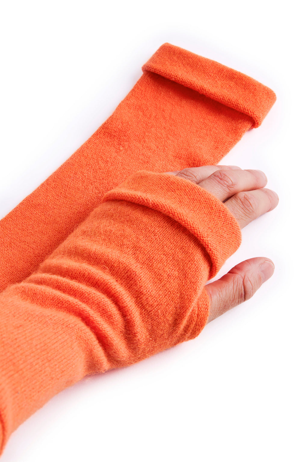 Turtle Doves Orange Cashmere Fingerless Gloves, worn on hands, side view