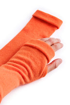 Turtle Doves Orange Cashmere Fingerless Gloves, worn on hands, side view