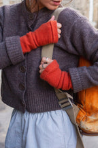 Turtle Doves Orange Cashmere Fingerless Gloves, worn with a cardigan