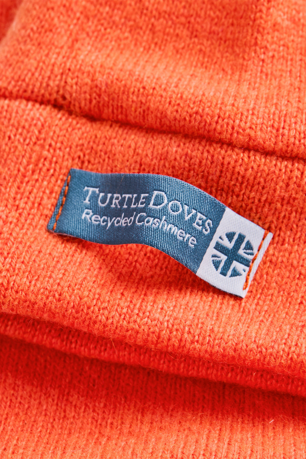 Turtle Doves Orange Cashmere Fingerless Gloves, cuff label close-up