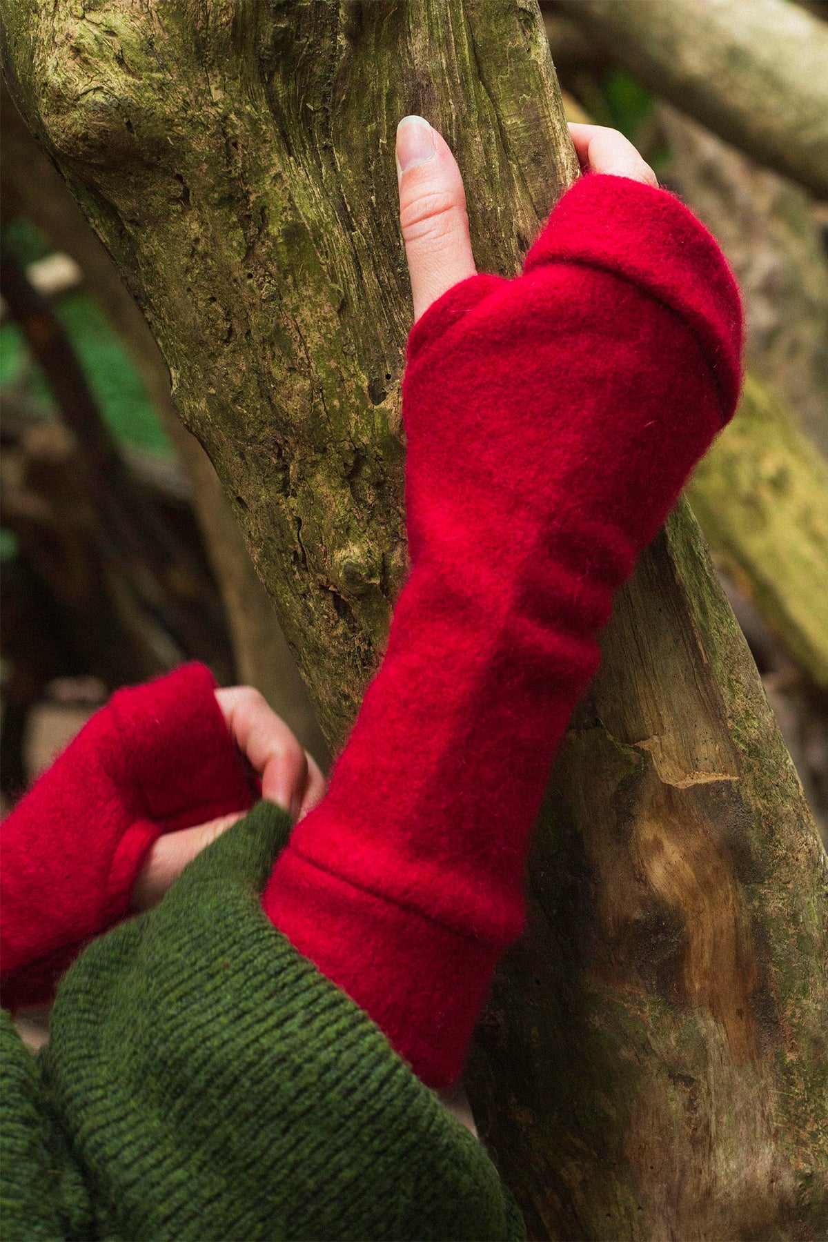 Turtle Doves Red Cashmere Fingerless Gloves, worn outdoors against a tree