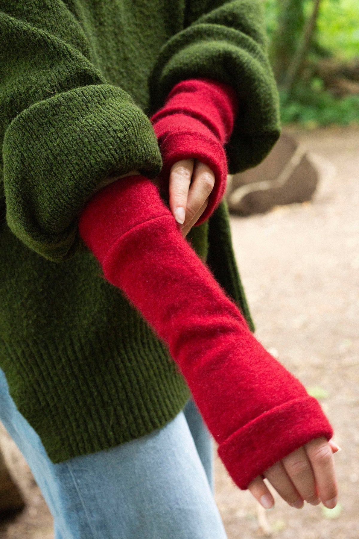 Turtle Doves Red Cashmere Fingerless Gloves, worn with a green jumper
