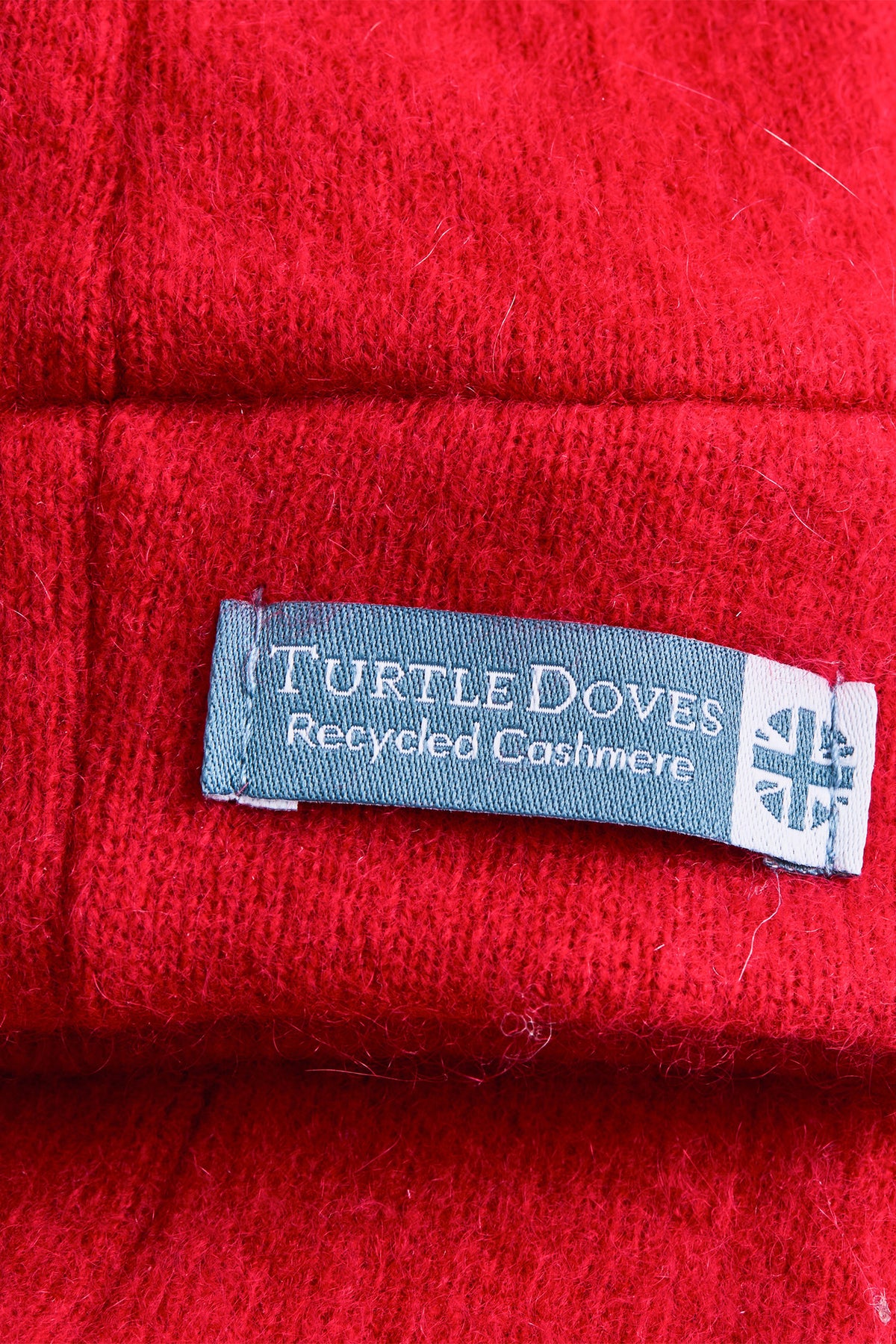 Turtle Doves Red Cashmere Fingerless Gloves, cuff label close-up