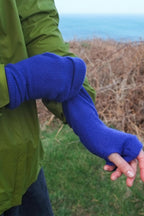 Turtle Doves Royal Blue Cashmere Fingerless Gloves, worn outdoors, arm outstretched