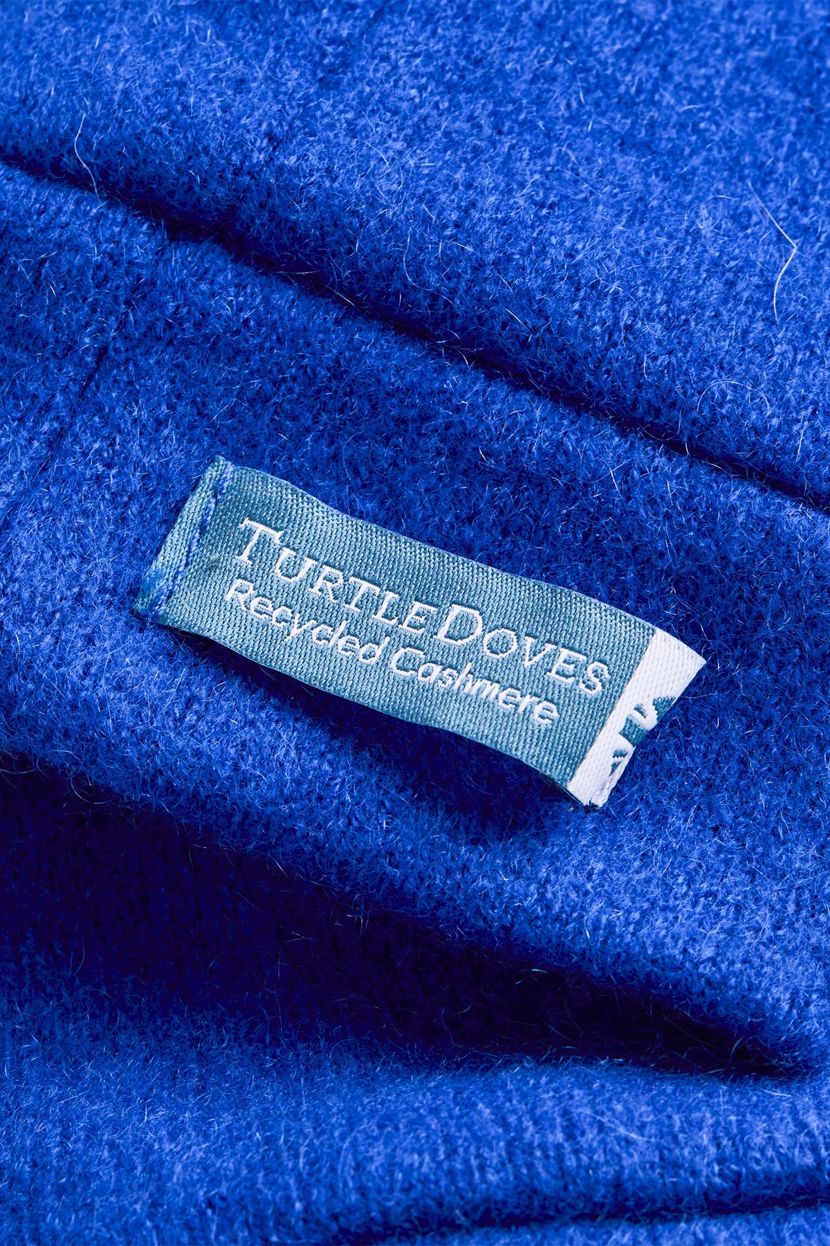 Turtle Doves Royal Blue Cashmere Fingerless Gloves, cuff label close-up