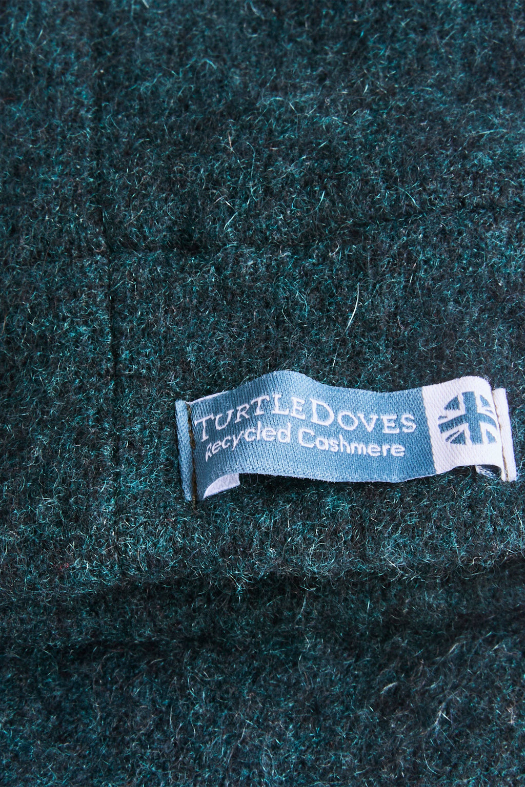 Turtle Doves Woodland Green Cashmere Fingerless Gloves, cuff label close-up