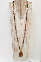 Wild Spirit Desert Dunes Brown Necklace, on display stand, full length view