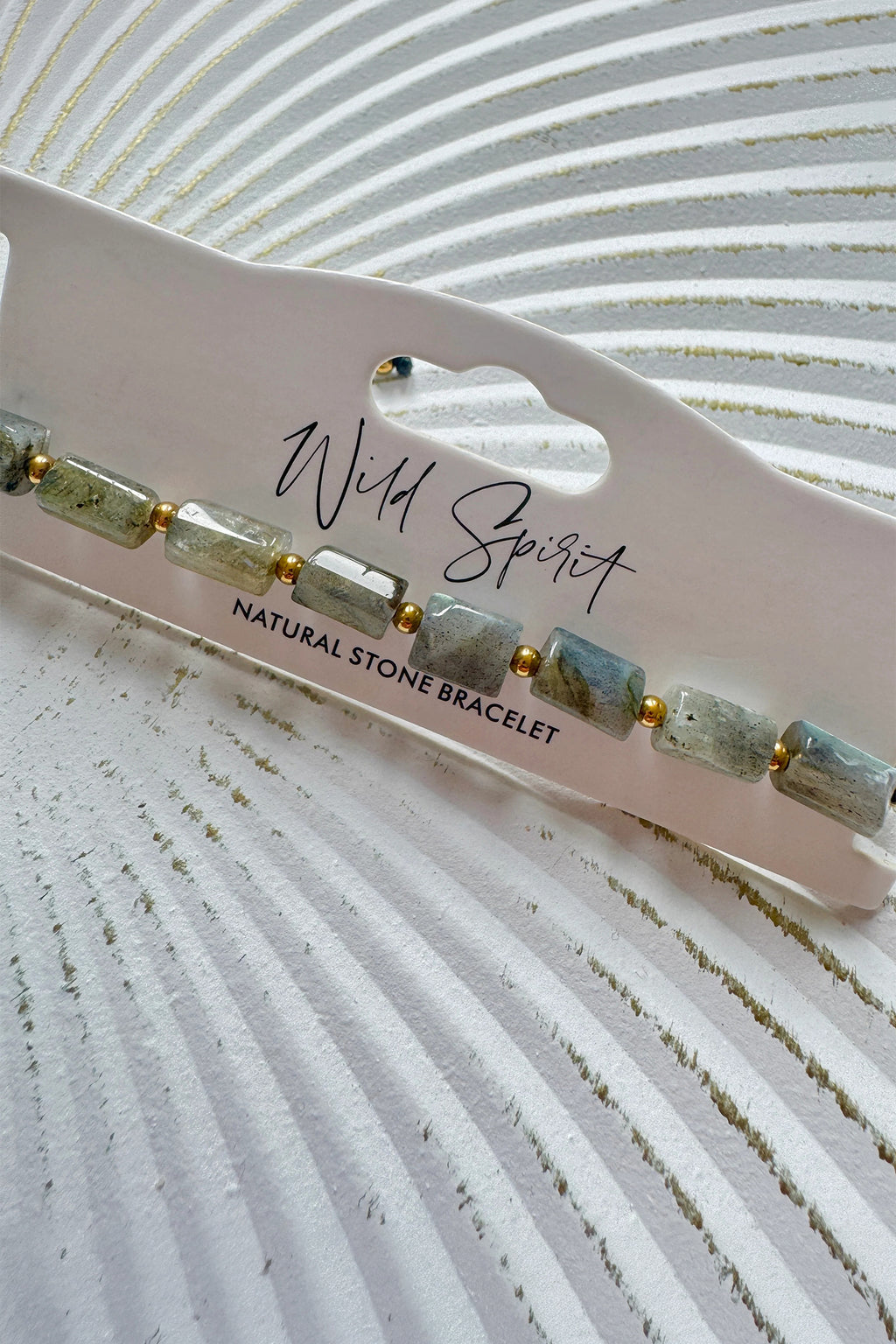 Wild Spirit Labradorite Grey Rock Bracelet, angled close-up on branded card