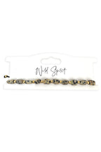 Wild Spirit The Dalmatian Beige Nomad Bracelet, flat lay on branded card