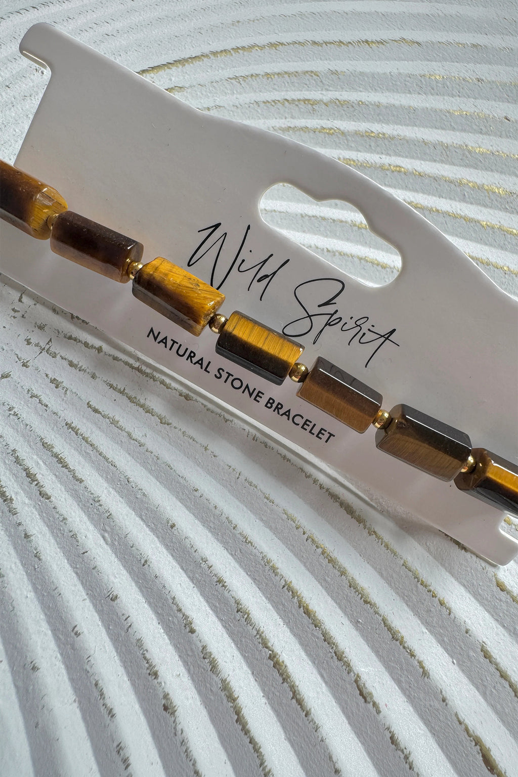 Wild Spirit Tiger Eye Brown Rock Bracelet, angled close-up on branded card